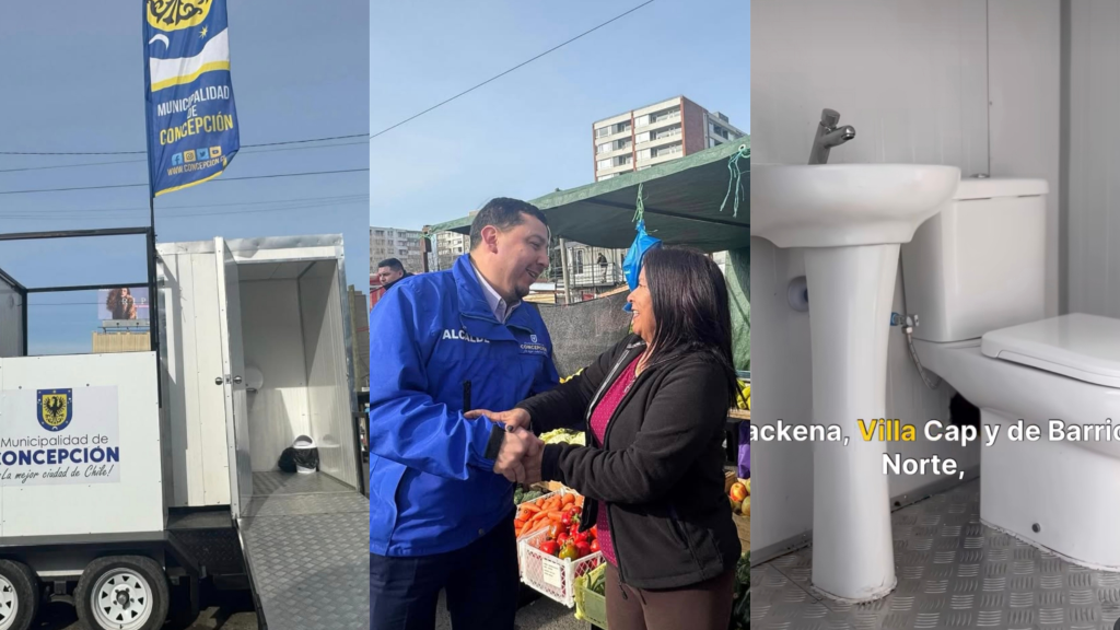 Módulo de baños públicos moderno y accesible en el exterior de una feria libre, con personas caminando de fondo.